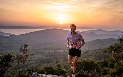 A trail runner ascends the peak of Ugljan Island at sunrise during the Archipelago Trail Run event.